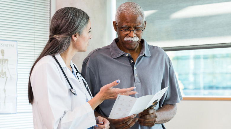 Doctor giving patient informational brochure