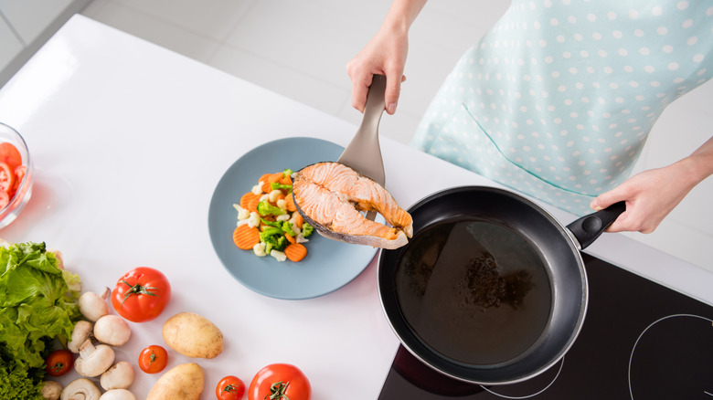 person preparing salmon steak