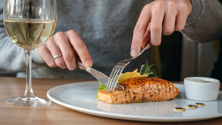 man cutting salmon