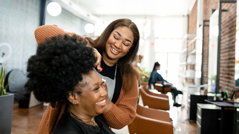 a woman brushing another woman's hair