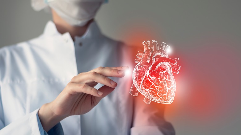 doctor touching virtual heart 