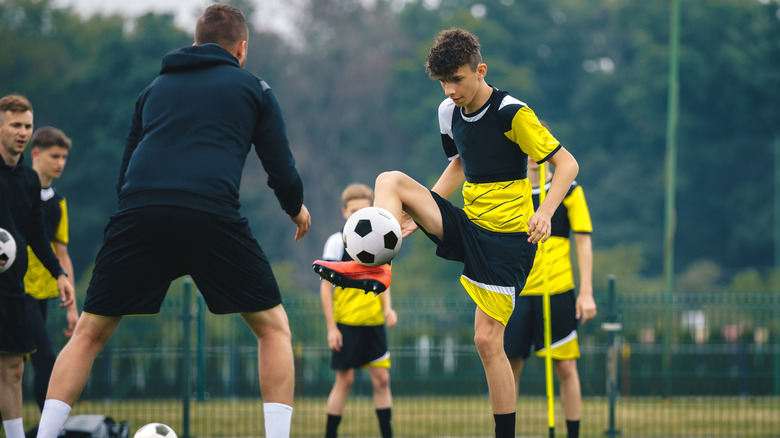 teenagers training at a soccer camp 