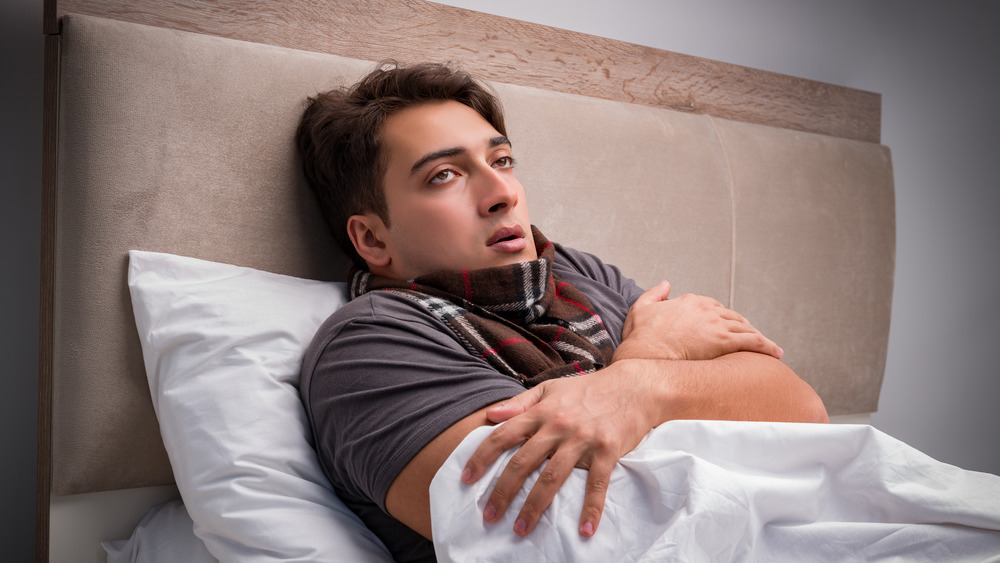 Sick man resting in bed