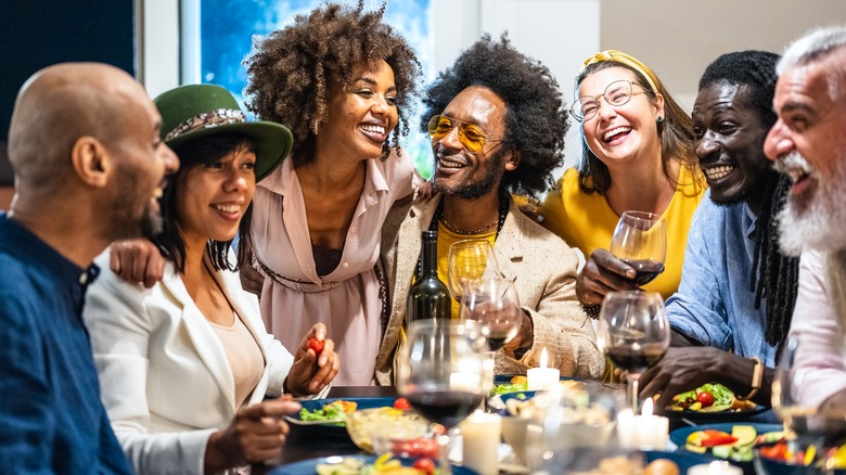 happy friends gathering for dinner