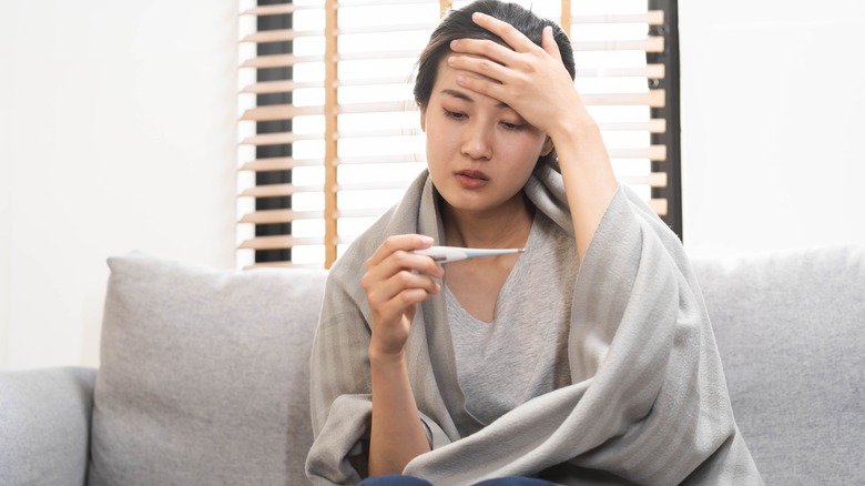 woman taking her temperature