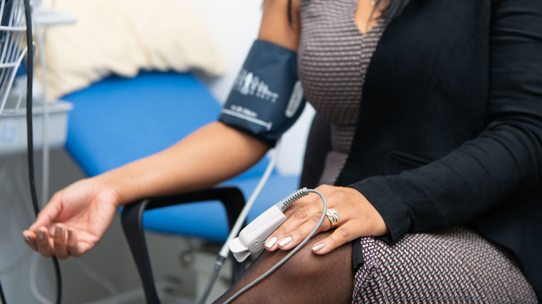 woman getting blood pressure taken 