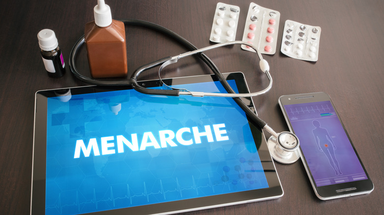 Device with text saying "MENARCHE"