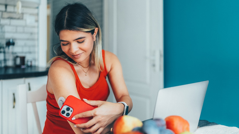 Young woman checking her blood sugar