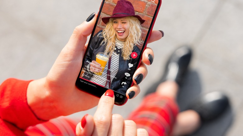 Woman watching a TikTok video on her phone