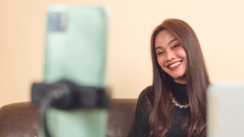 woman recording video on her phone