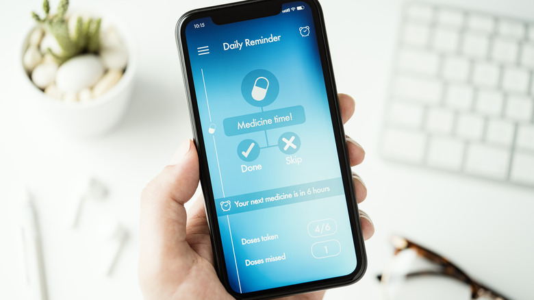phone with medicine reminder app displayed