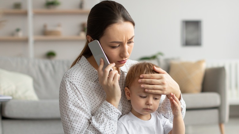 A mother checking a child for fever