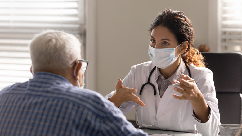 doctor talking with senior patient