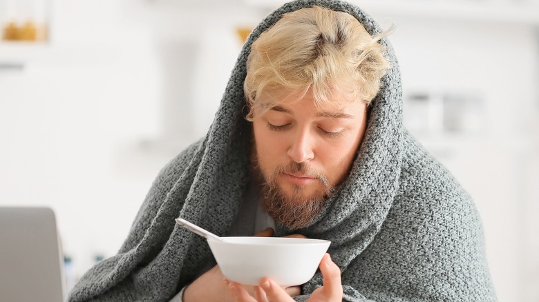 Sick man holding bowl