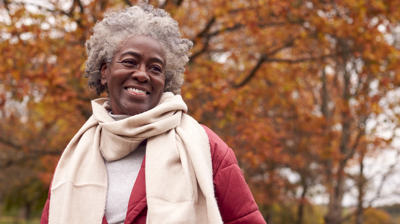 Smiling woman outdoors in autumn