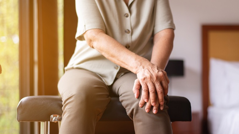 Senior adult holding knee