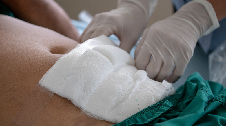 Healthcare worker applying gauze to patient