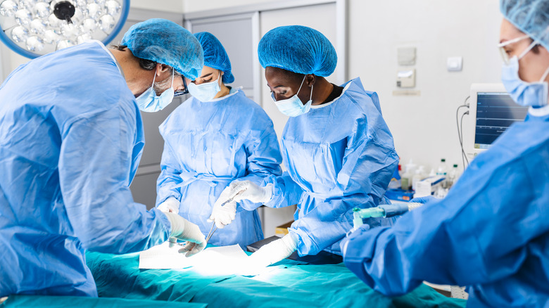 A surgical team performs a surgery