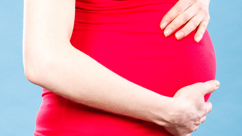woman holding pregnant belly 