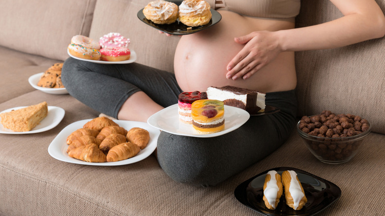 pregnant woman with different foods 