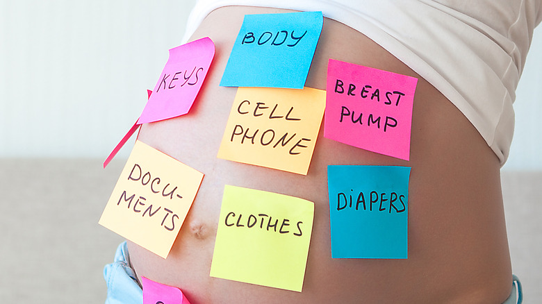 post-it notes on pregnant belly