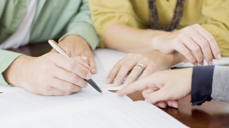 People completing paperwork