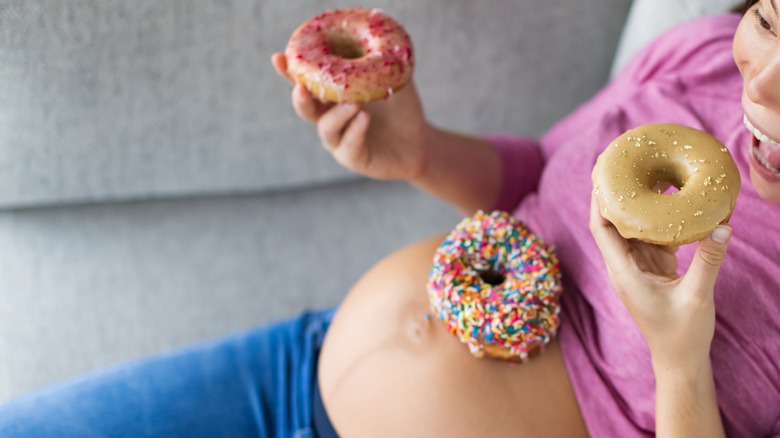 pregnant woman eating donuts