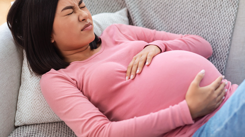 woman holding belly having contractions 
