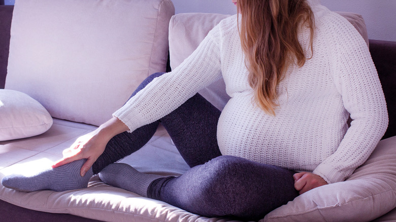 woman holding feet 