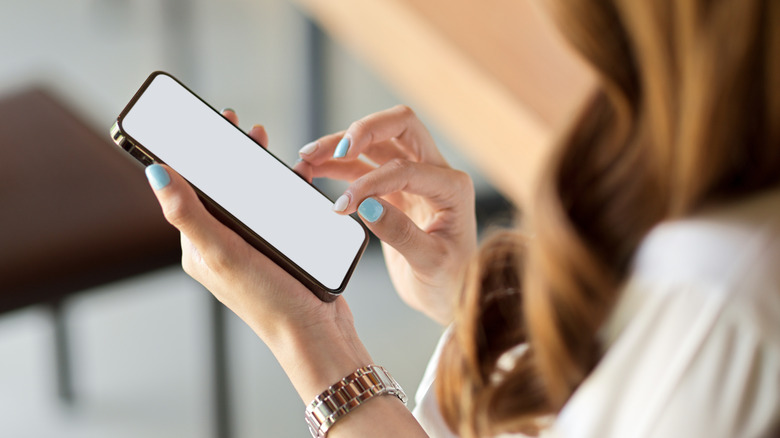 a woman scrolls social media 