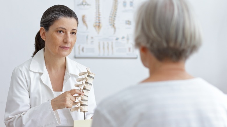doctor showing patient a spine model