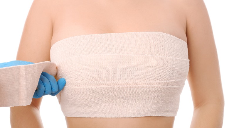 Bandage wrapped around woman's breasts