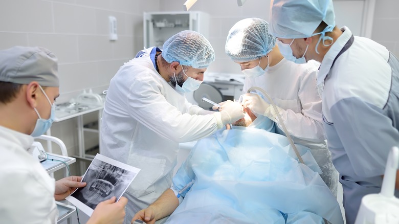 A patient gets dental surgery