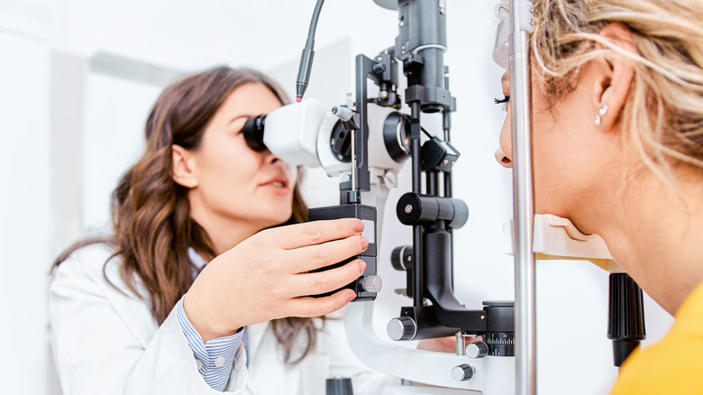 Optometrist giving examination of the eyes in ophthalmology clinic