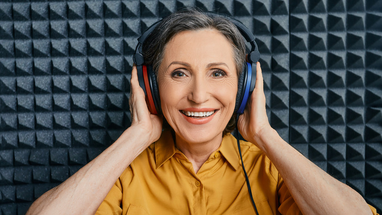 Woman wearing headphones in sound booth