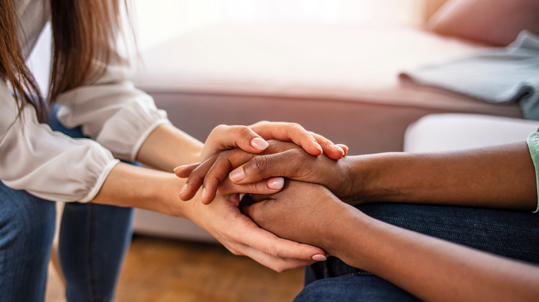 people holding hands during therapy