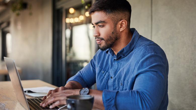 man looking through websites online