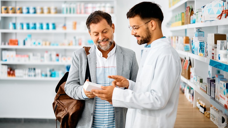 pharmacist and customer talking about prices