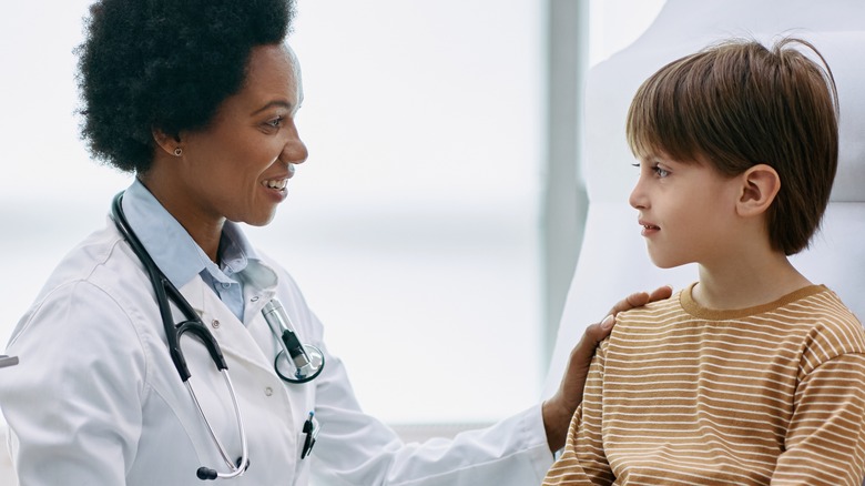 Doctor speaking with young boy