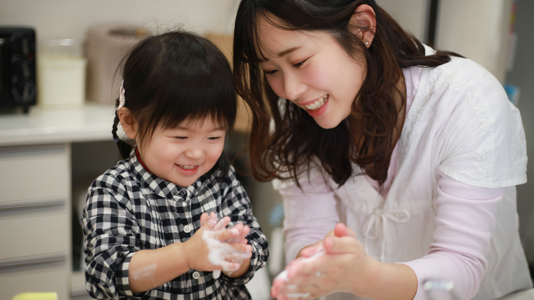 Parent and child washing hands