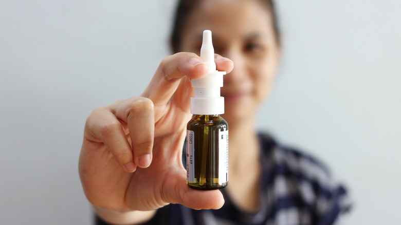 Nasal spray with woman in background