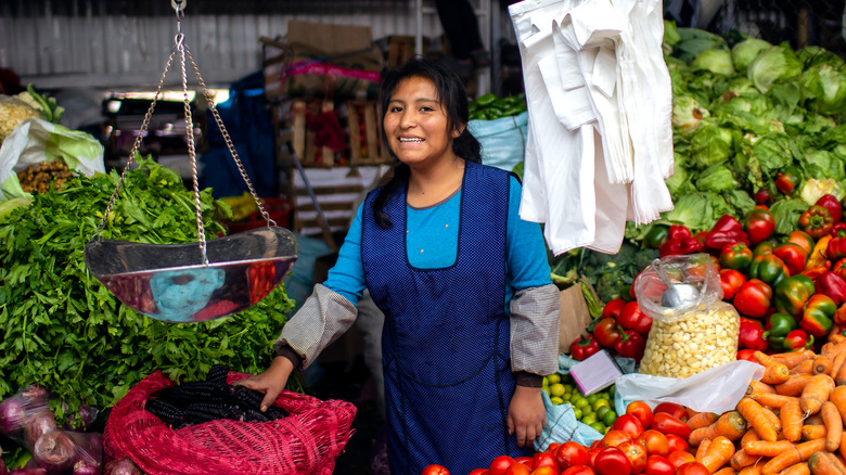 Indigenous woman with veggie farmer's market spread
