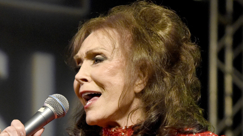 Loretta Lynn singing wearing red