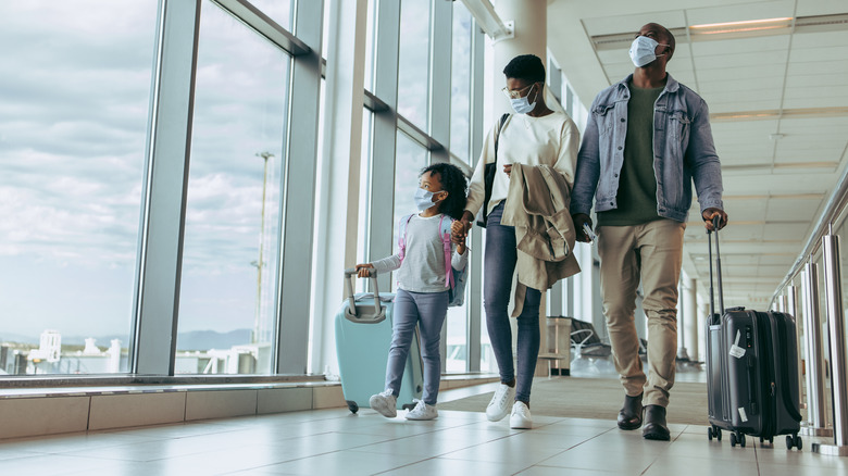 Family wearing masks at airport 