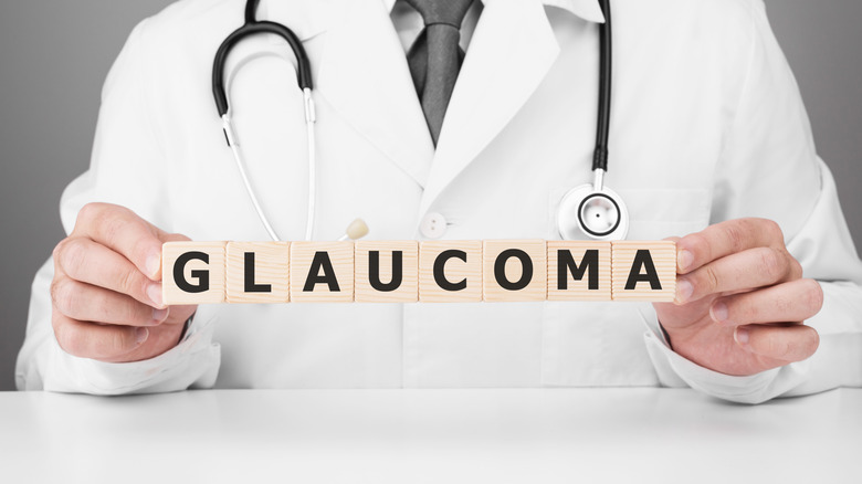 Doctor holding wooden blocks spelling "Glaucoma"