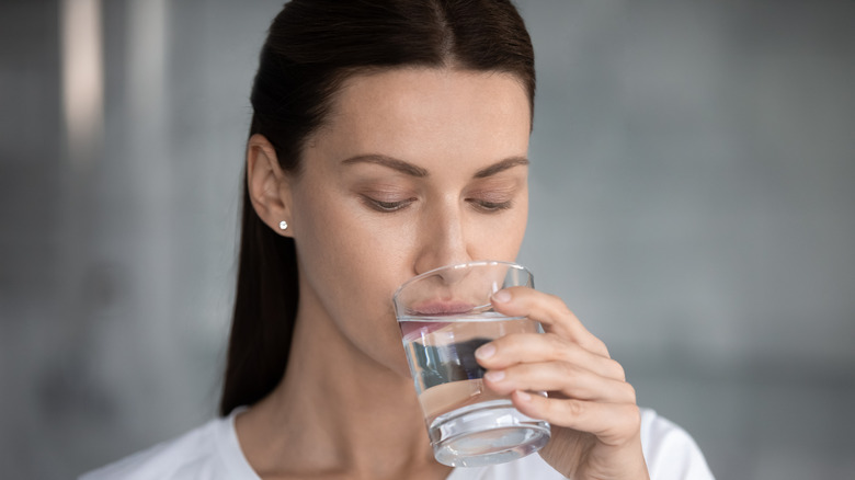 Close-up of a woman sipping water