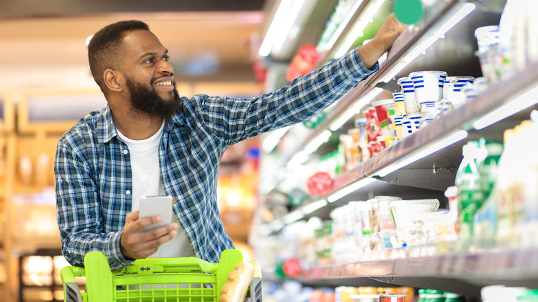 Man at grocery store choosing food