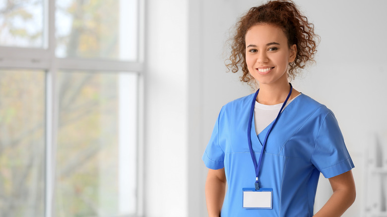 young doctor standing near window