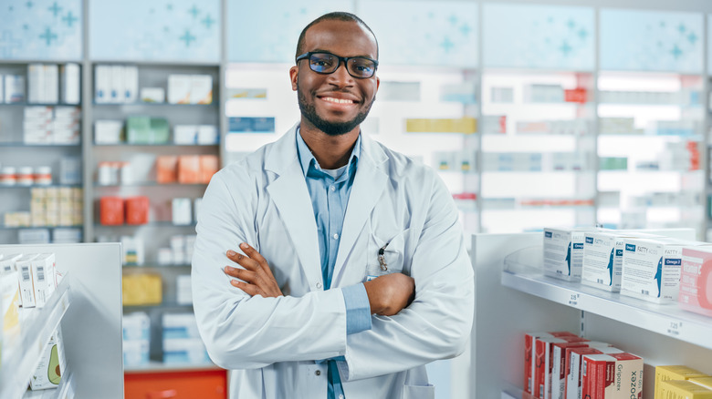 pharmacist in pharmacy with arms crossed 