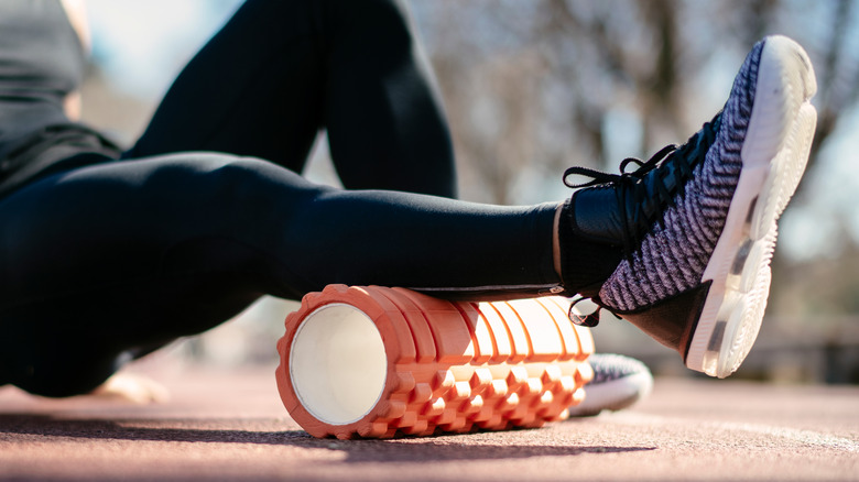 person using foam roller